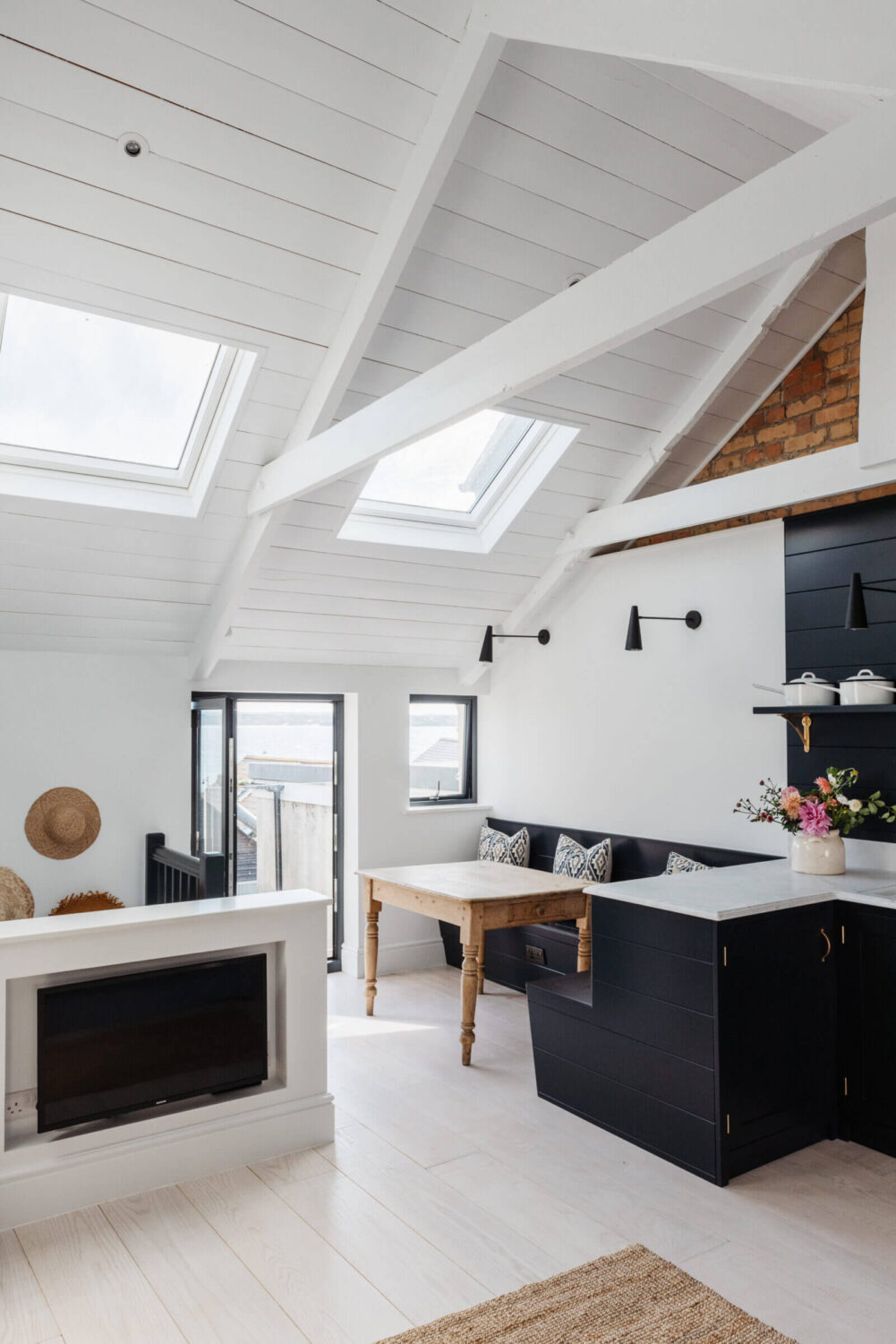 open-plan-sitting-room-kitchen-slanted-ceiling-skylights-nordroom
