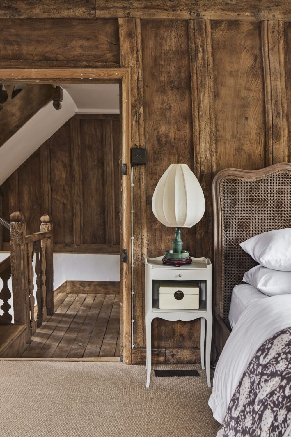 bedroom-antique-headboard-wooden-walls-nordroom
