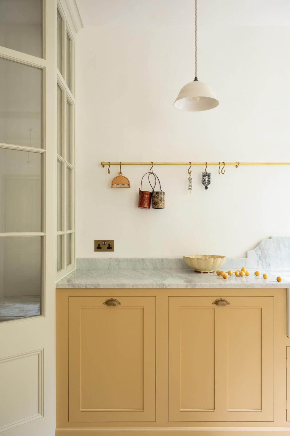 brass-hanging-rail-devol-kitchens-yellow-cabinets-nordroom