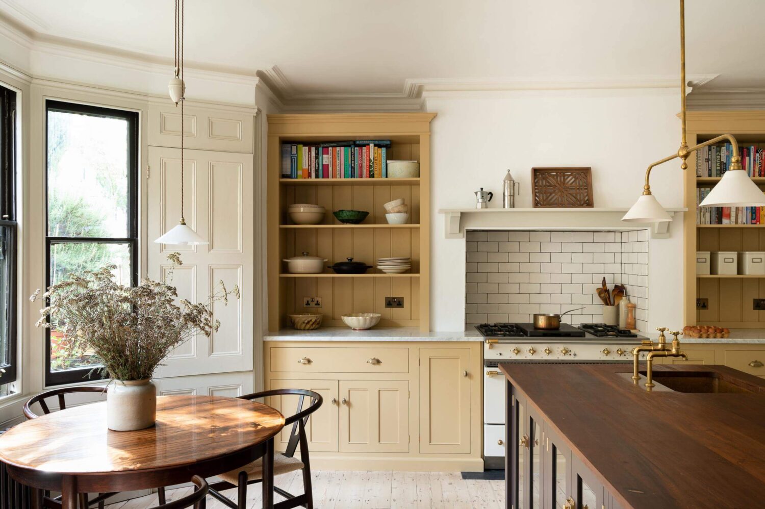 devol-kitchen-yellow-brown-cabinets-round-table-bay-window-nordroom