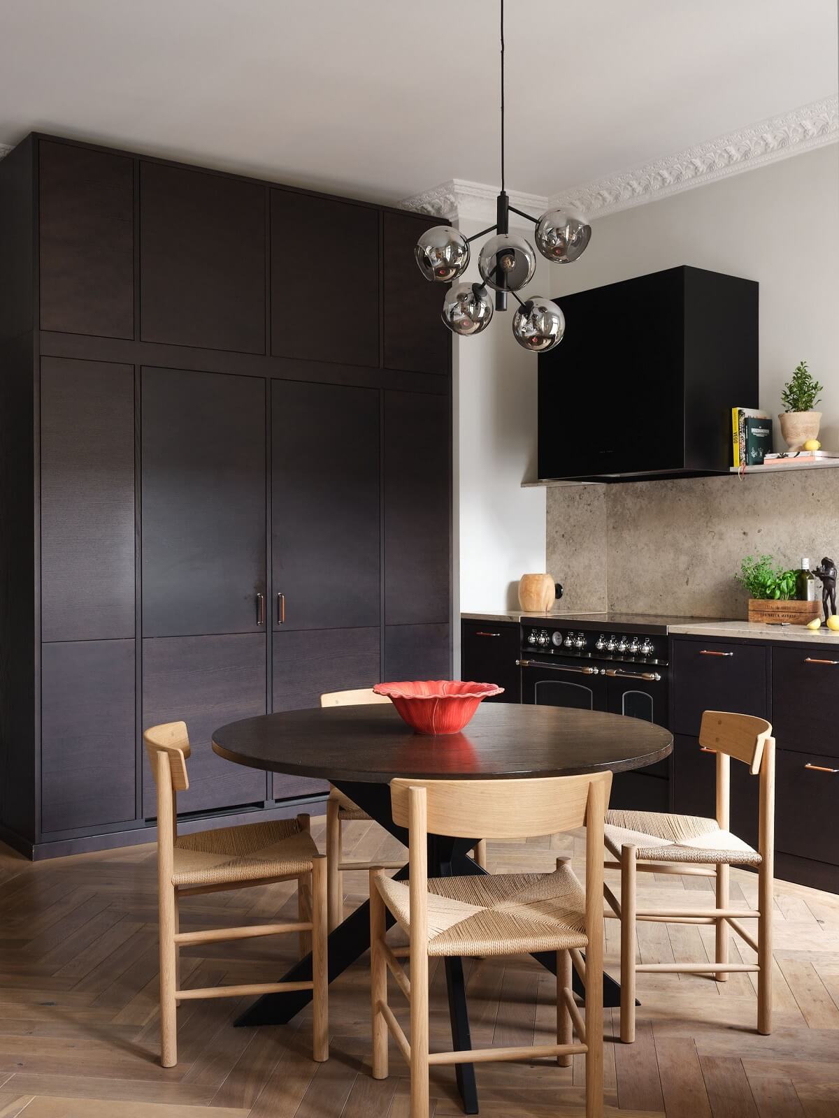 kitchen-round-dining-table-dark-cupboards-floor-to-ceiling-cabinets-nordroom