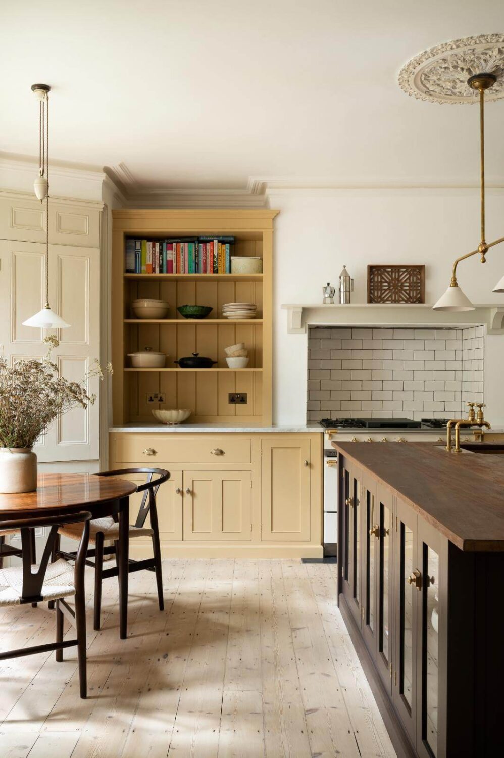 kitchen-round-dining-table-island-yellow-cabinets-open-shelves-nordroom