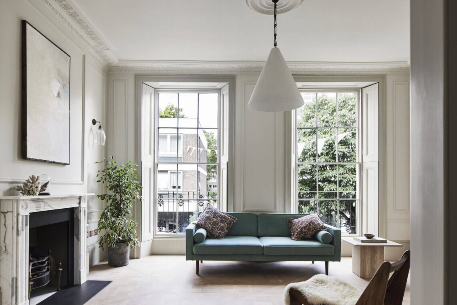 minimalistic-living-room-light-blue-sofa-fireplace-stucco-nordroom