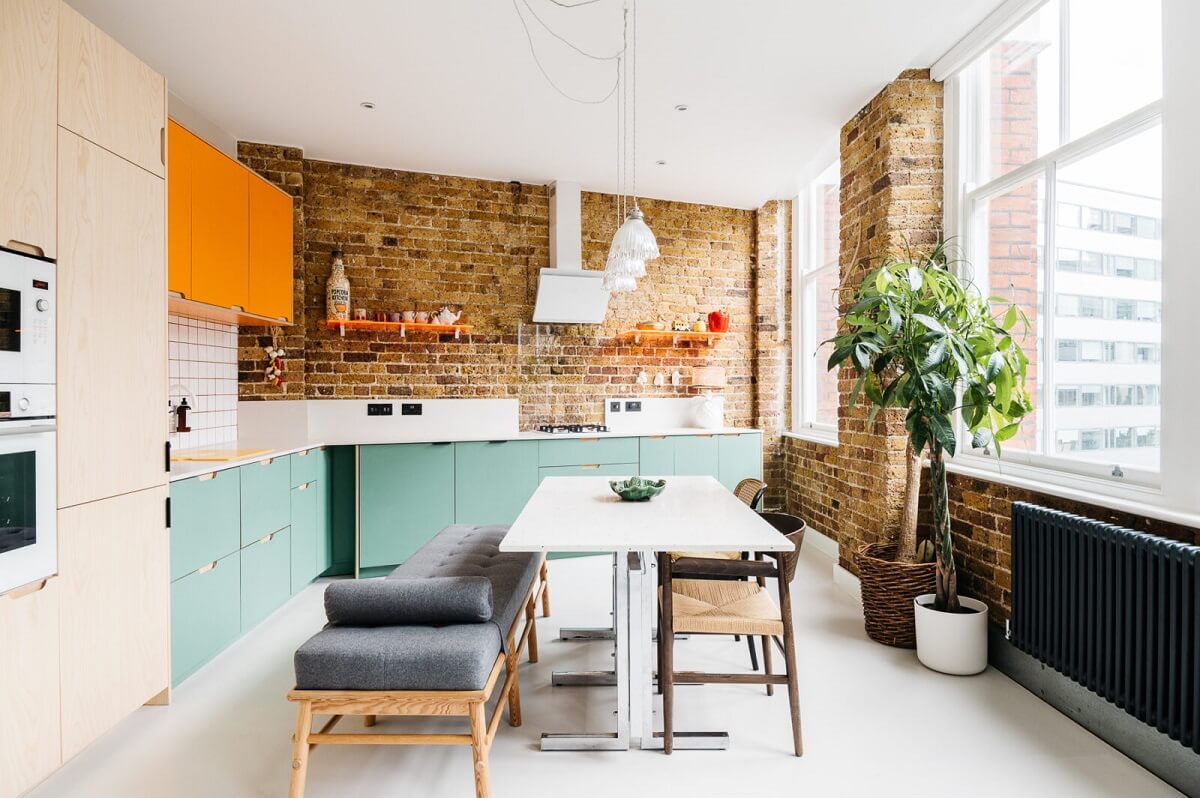 modern-kitchen-pale-green-orange-cabinets-brick-walls-nordroom