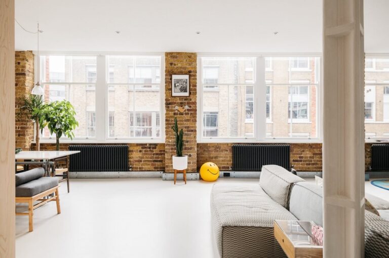 Image showcasing A Modern Apartment with Exposed Brick Walls and Color Accents - The ...