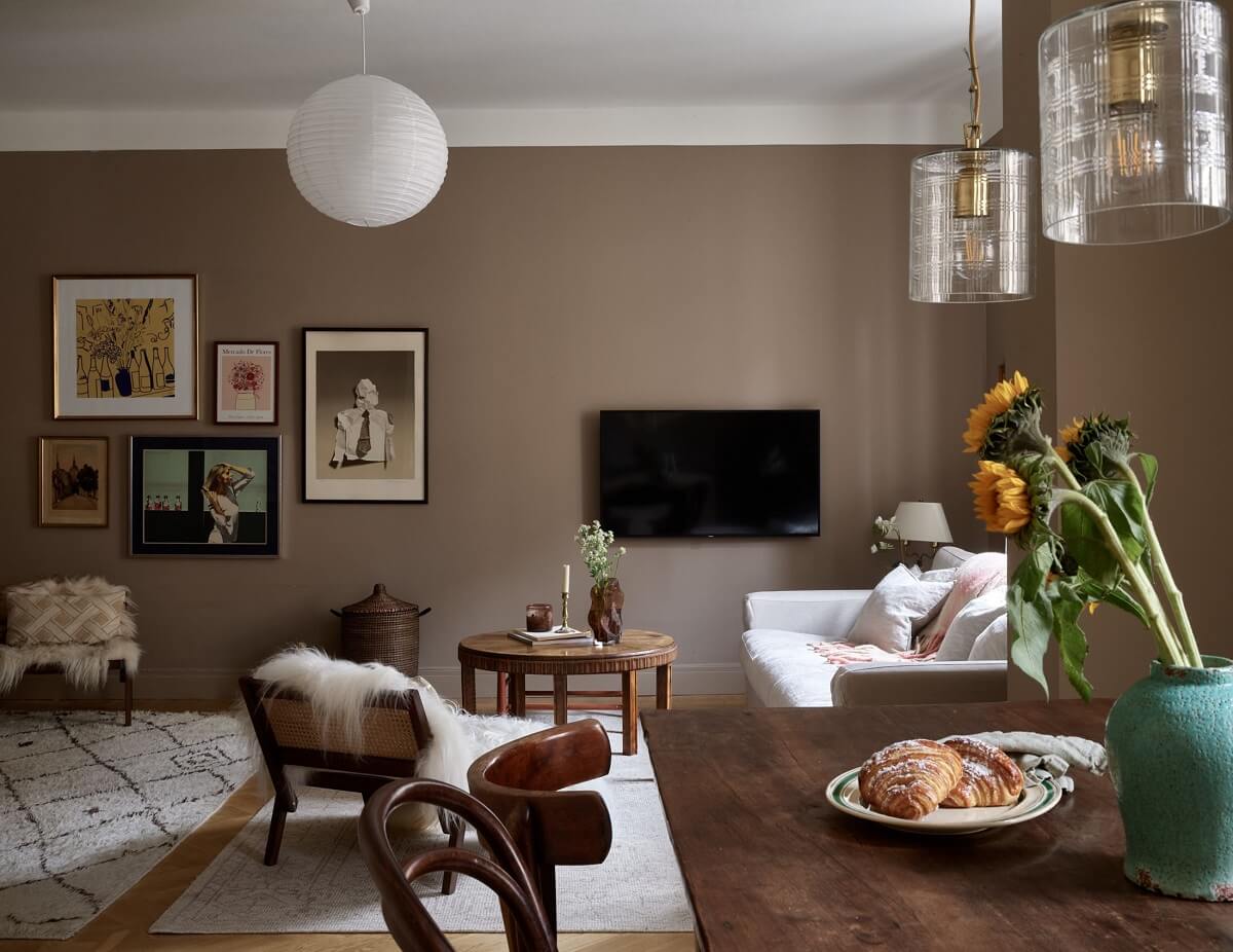 open-plan-living-room-wooden-dining-table-brown-walls-nordroom