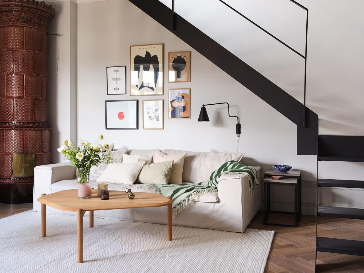 sitting-area-under-black-staircase-brown-fireplace-nordroom