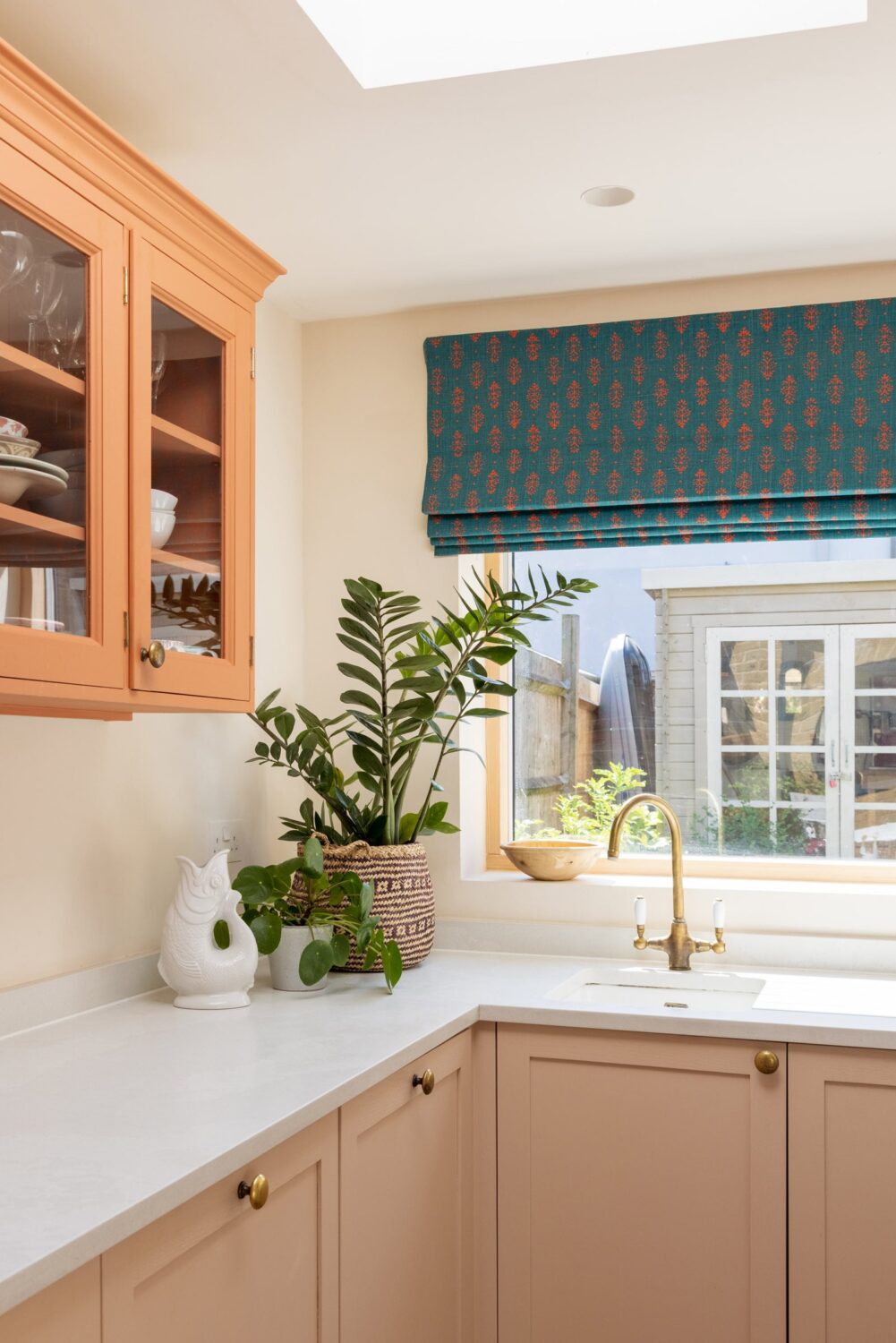 small-kitchen-orange-cabinet-skylight-blue-curtain-nordroom