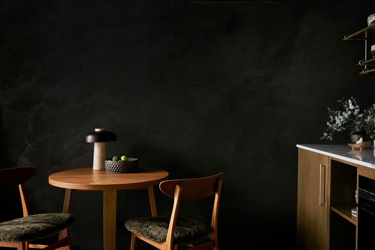 small-round-kitchen-table-black-walls-studio-apartment-nordroom