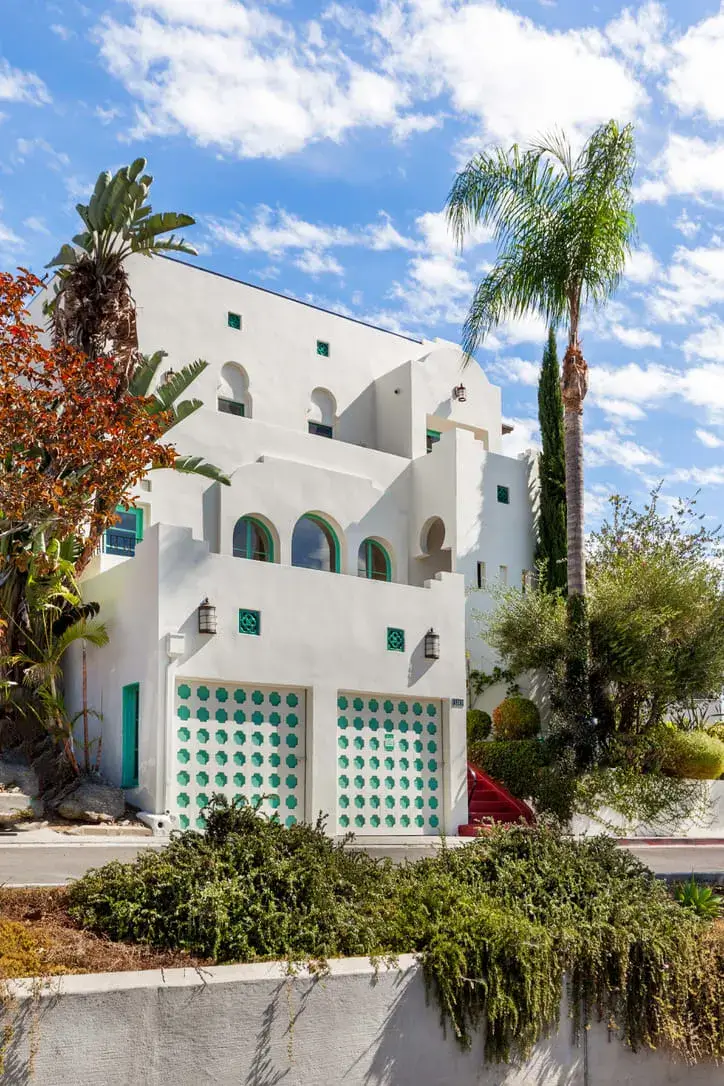 white exterior blue accents spanish style villa nordroom A Bright Spanish-Style Villa in Los Angeles