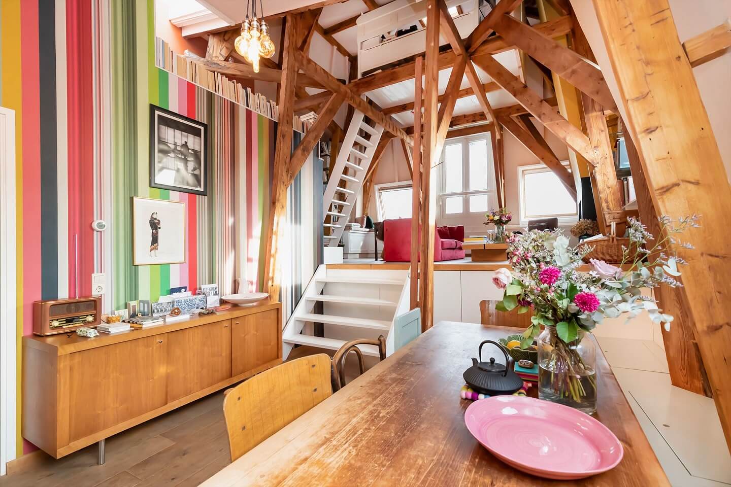 colorful-loft-dining-space-wooden-beams-nordroom