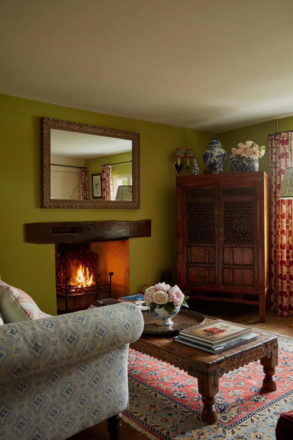 cottage-sitting-room-antique-furnishings-green-walls-fireplace-nordroom