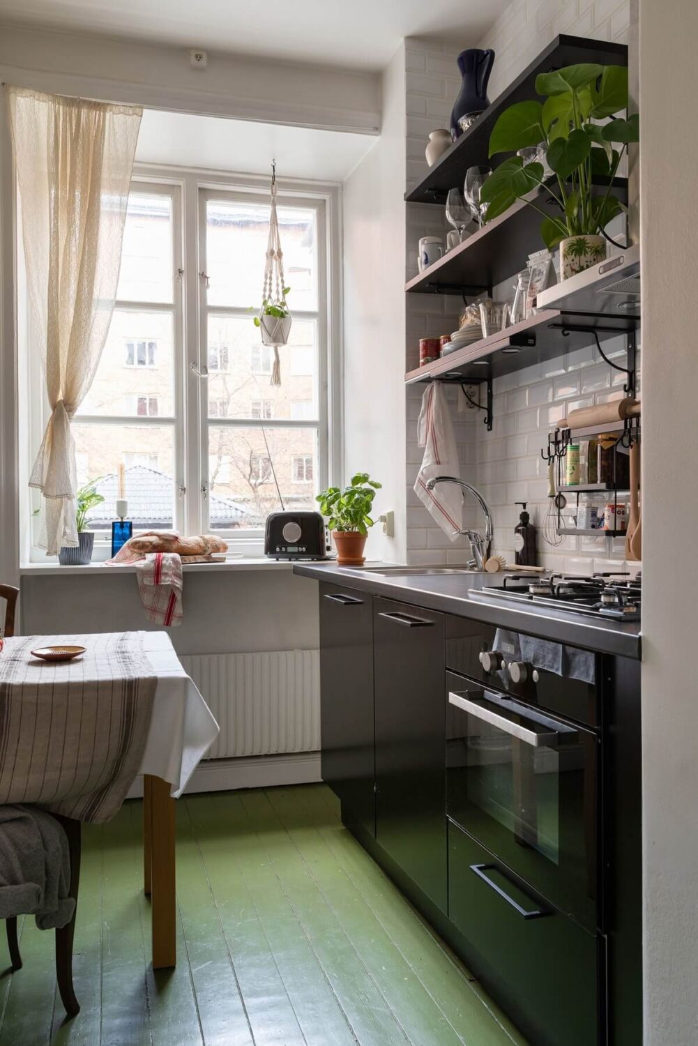 kitchen-black-cabinets-open-shelves-green-painted-floor-nordroom