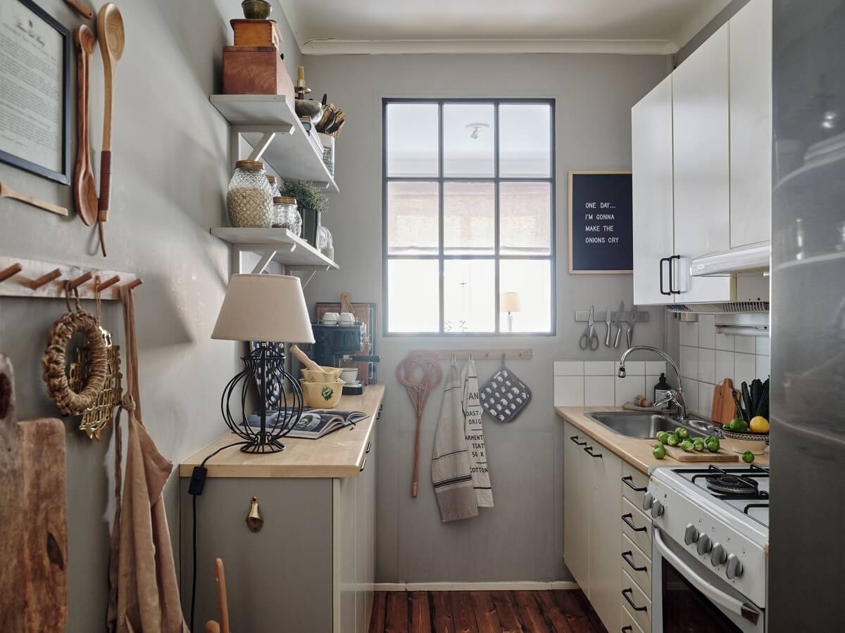 small-galley-kitchen-light-gray-walls-shelves-window-nordroom
