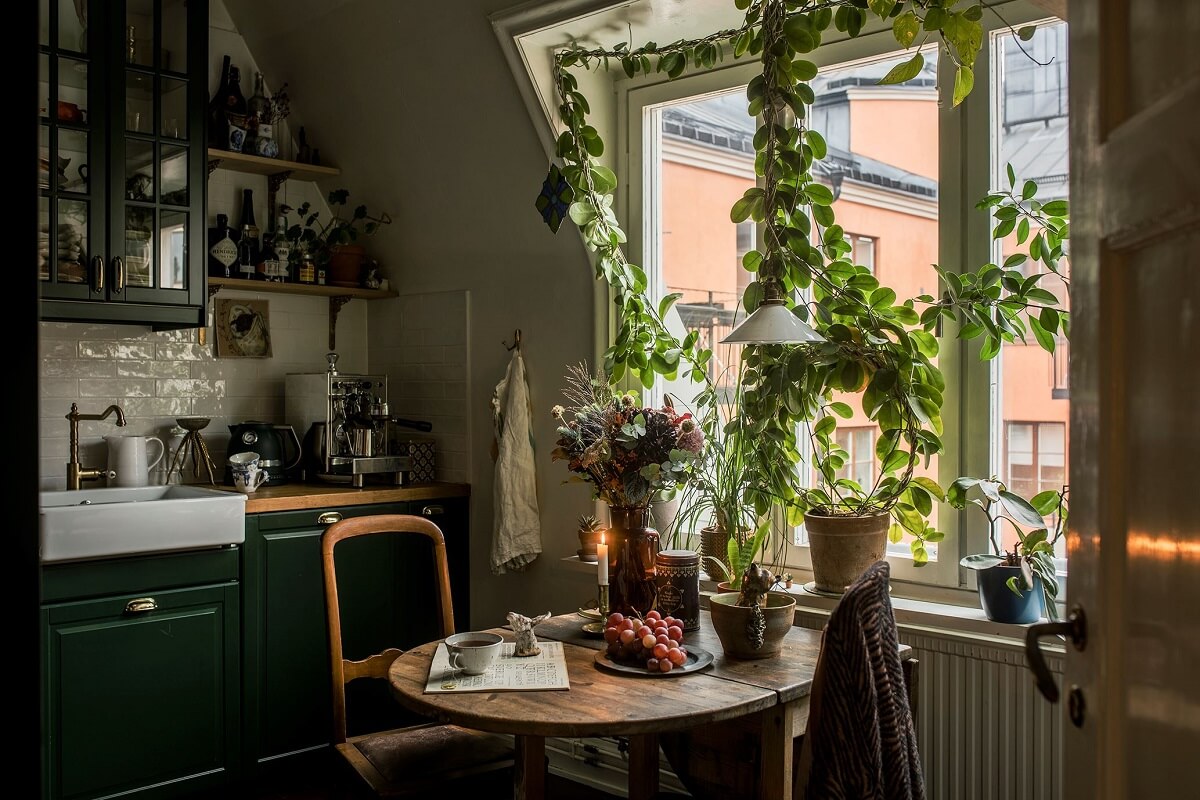 small-kitchen-slanted-wall-plants-green-cupboards-nordroom