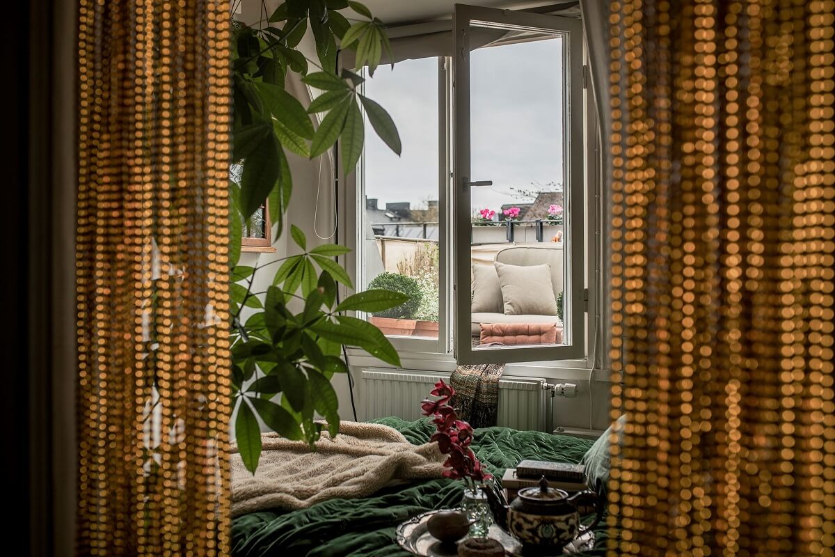 tiny-bedroom-balcony-green-bedding-nordroom