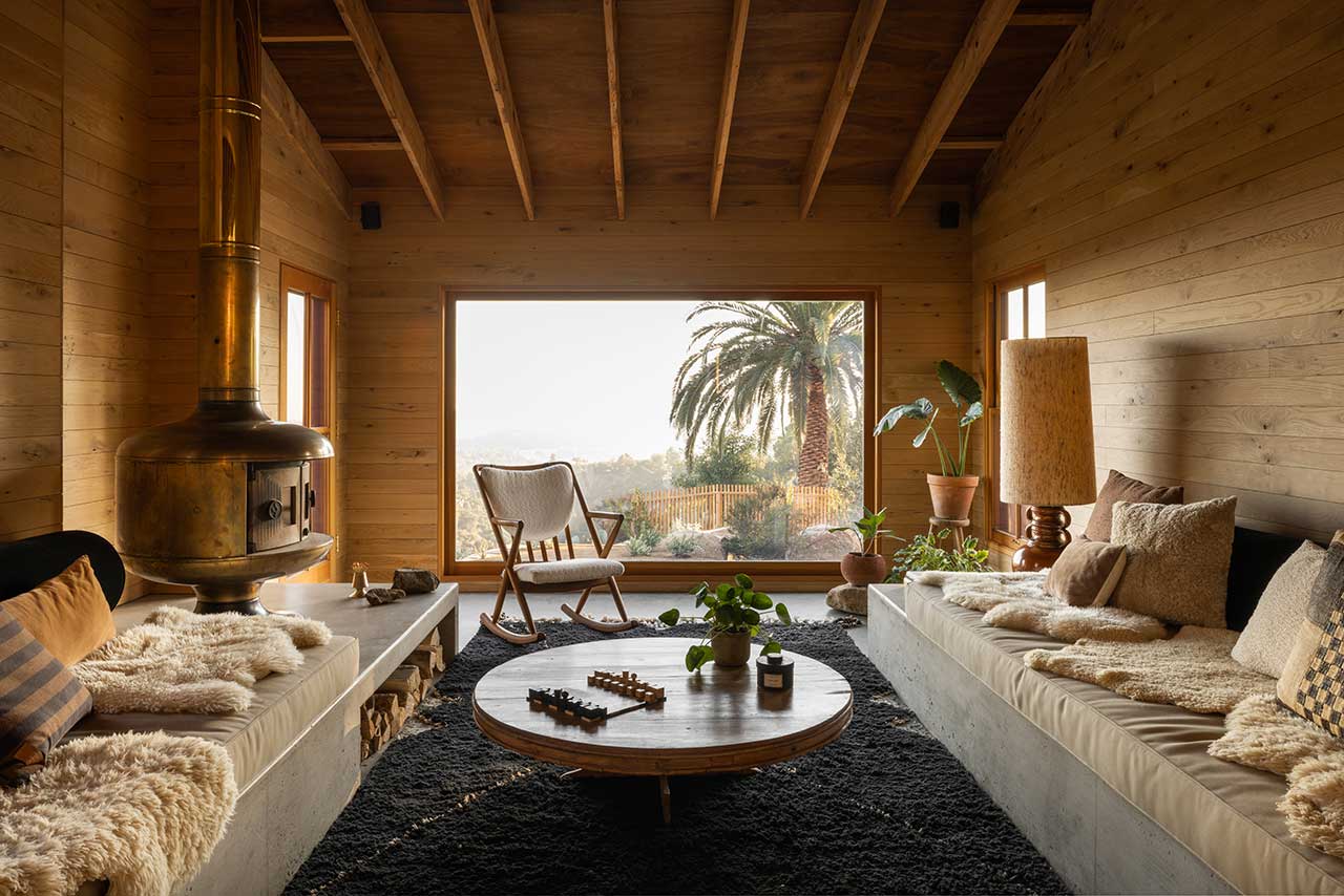 Mountaintop-Home-Altadena-William-Hunter-Collective-Living-room-built-in-sofa-woodburner-panorama-window-nordroom