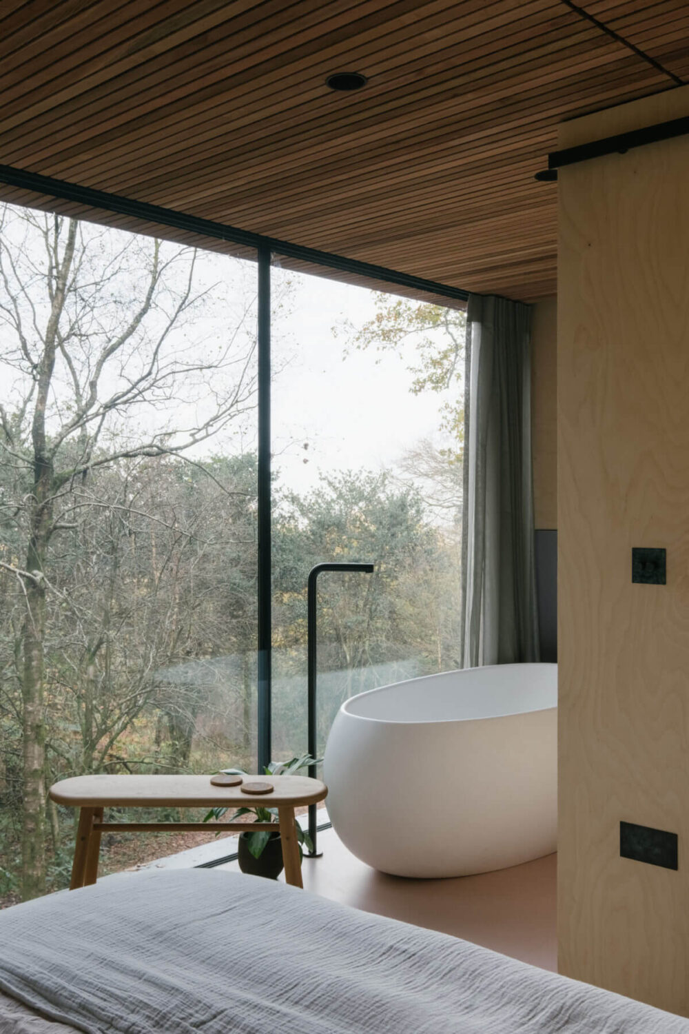 bedroom-en-suite-freestanding-bath-floor-to-ceiling-windows-nodroom