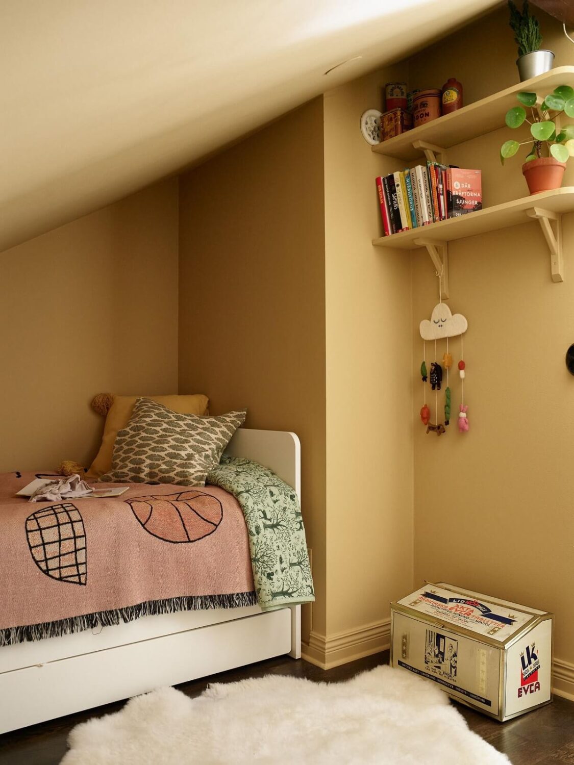 kids-bedroom-yellow-walls-shelfs-slanted-ceiling-nordroom