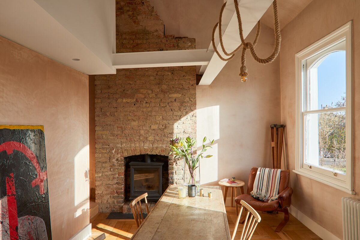 kitchen-dining-space-exposed-brick-wall-firpelace-high-ceiling-nordroom