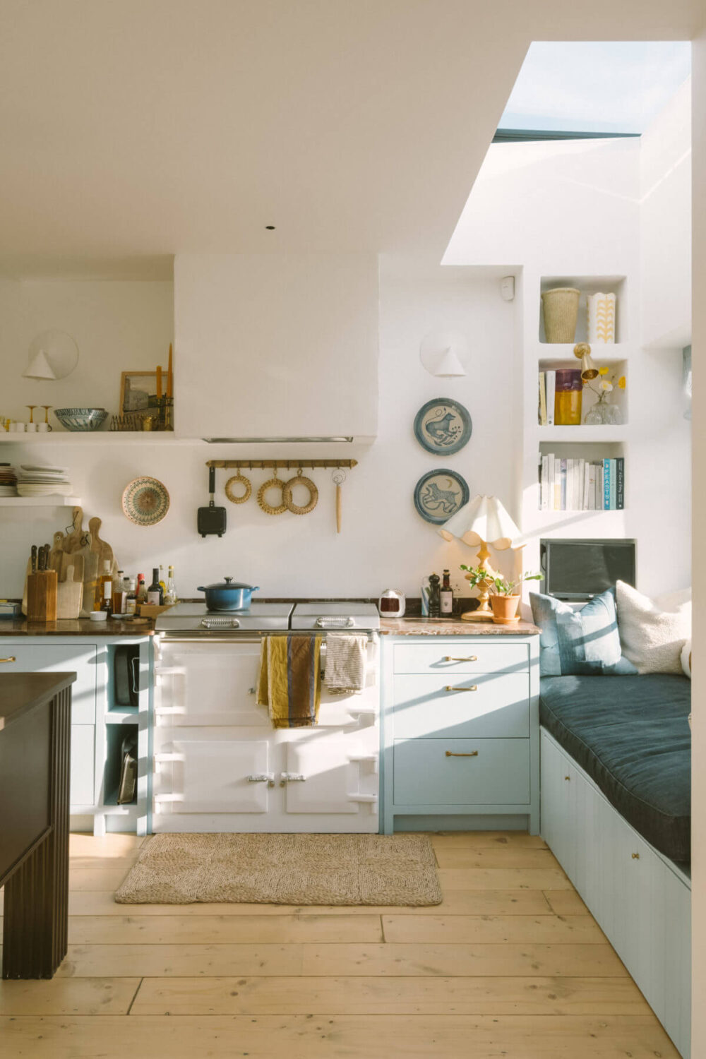 kitchen-window-seat-skylight-light-blue-cabinets-aga-stove-wooden-floor-nordroom