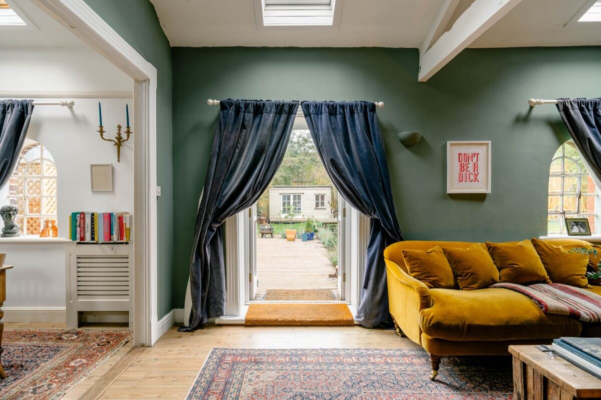 sitting-room-blue-curtains-green-walls-ochre-yellow-sofa-skylights-nordroom