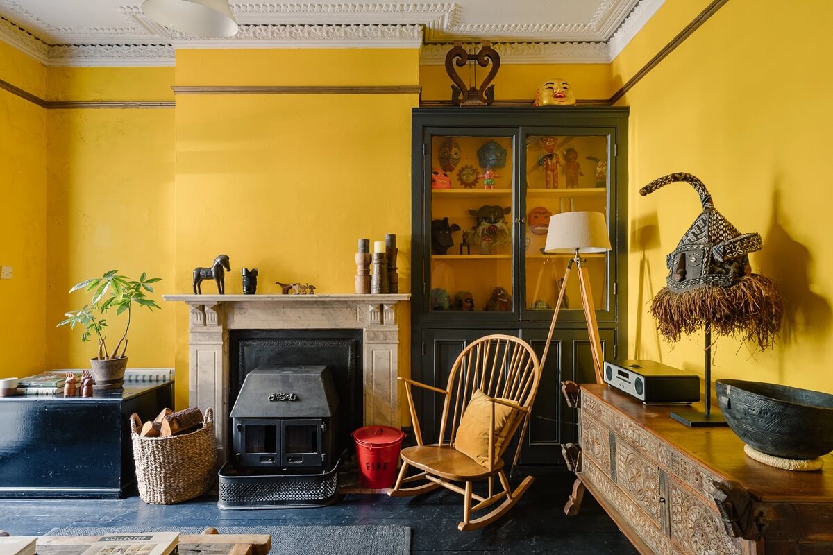 yellow-walls-sitting-room-fireplace-rocking-chair-dark-floor-nordroom