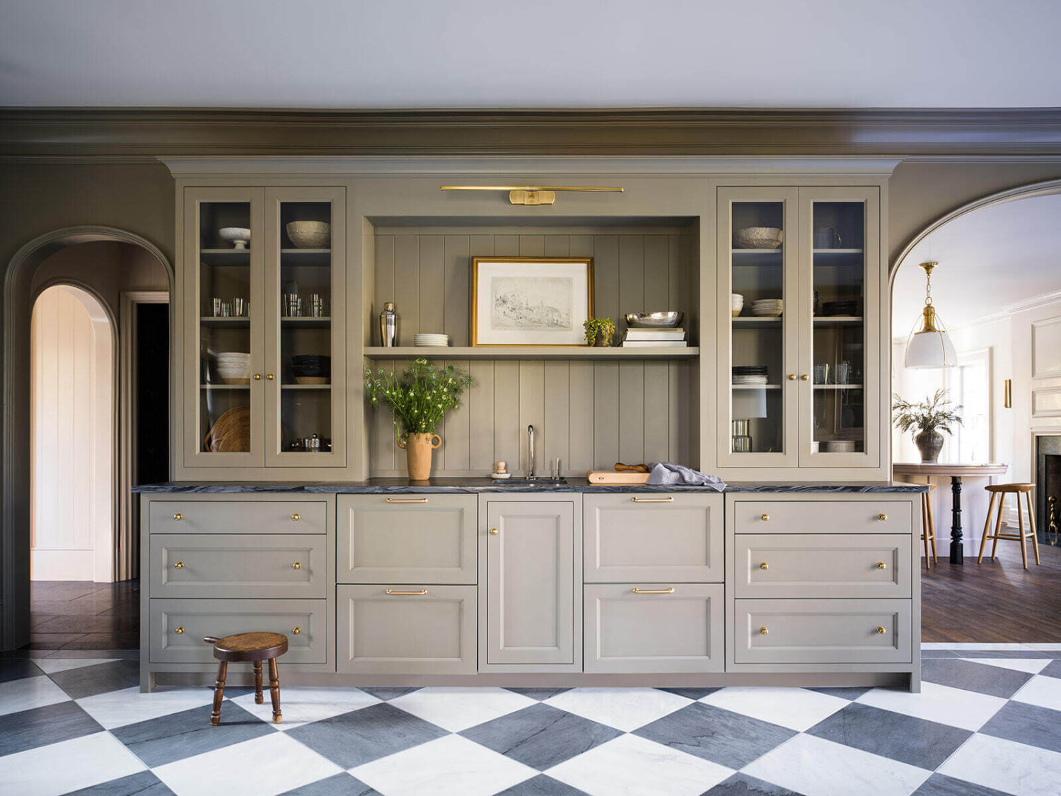 built-in-cabinets-bar-sink-checkerboard-floor-arches-living-room-nordroom