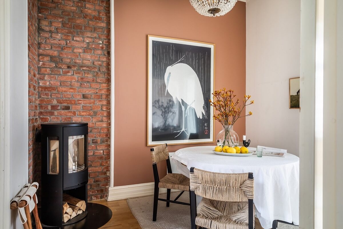 dining-room-exposed-brick-wall-fireplace-earthy-brown-wall-nordroom