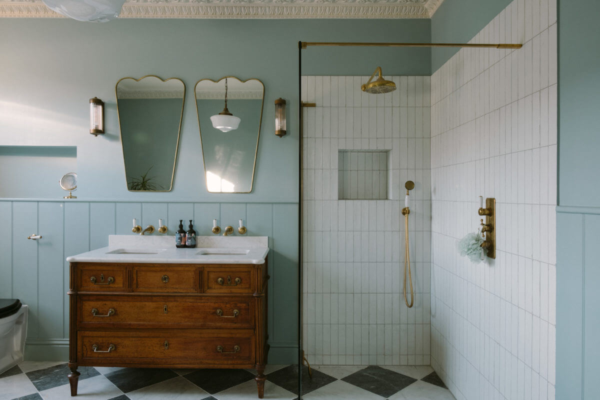 light-blue-bathroom-antique-vanity-walk-in-shower-checkerboard-floor-nordroom