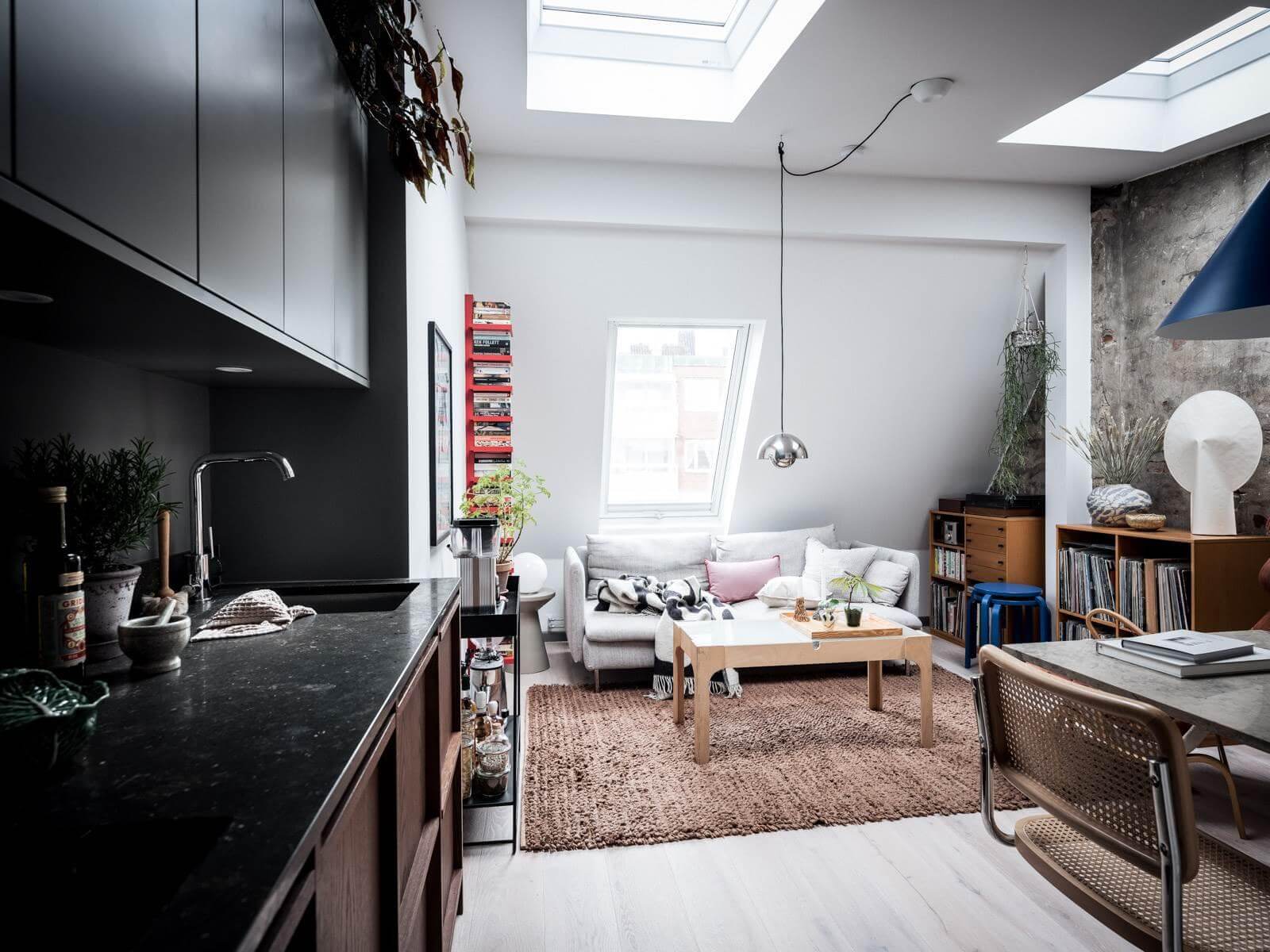 A Small Scandinavian Loft with Skylights and Brick Wall