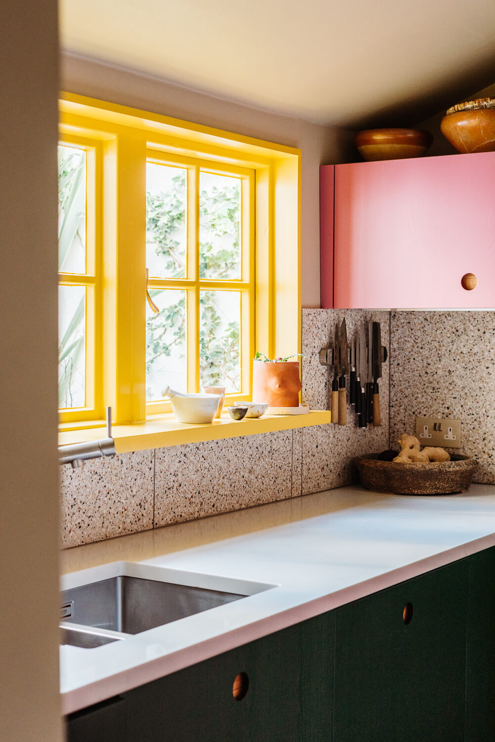 small-kitchen-pink-green-cabinets-yellow-window-nordroom