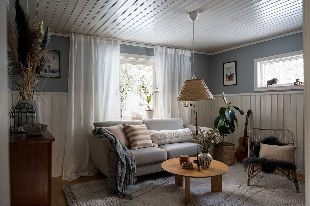 small-living-room-wood-paneling-light-blue-walls-nordroom