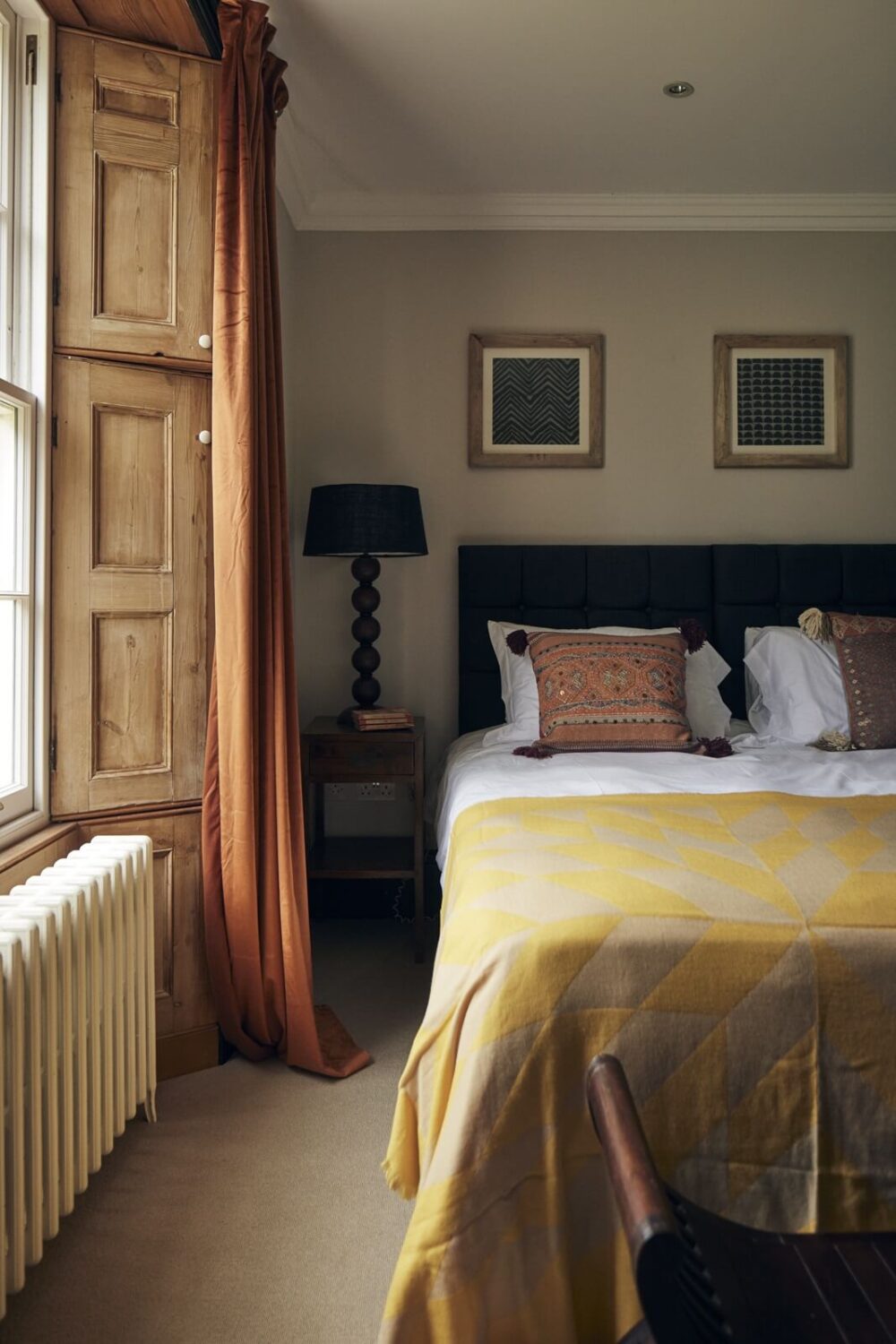 bedroom-light-gray-walls-wooden-shutters-yellow-bedspread-nordroom