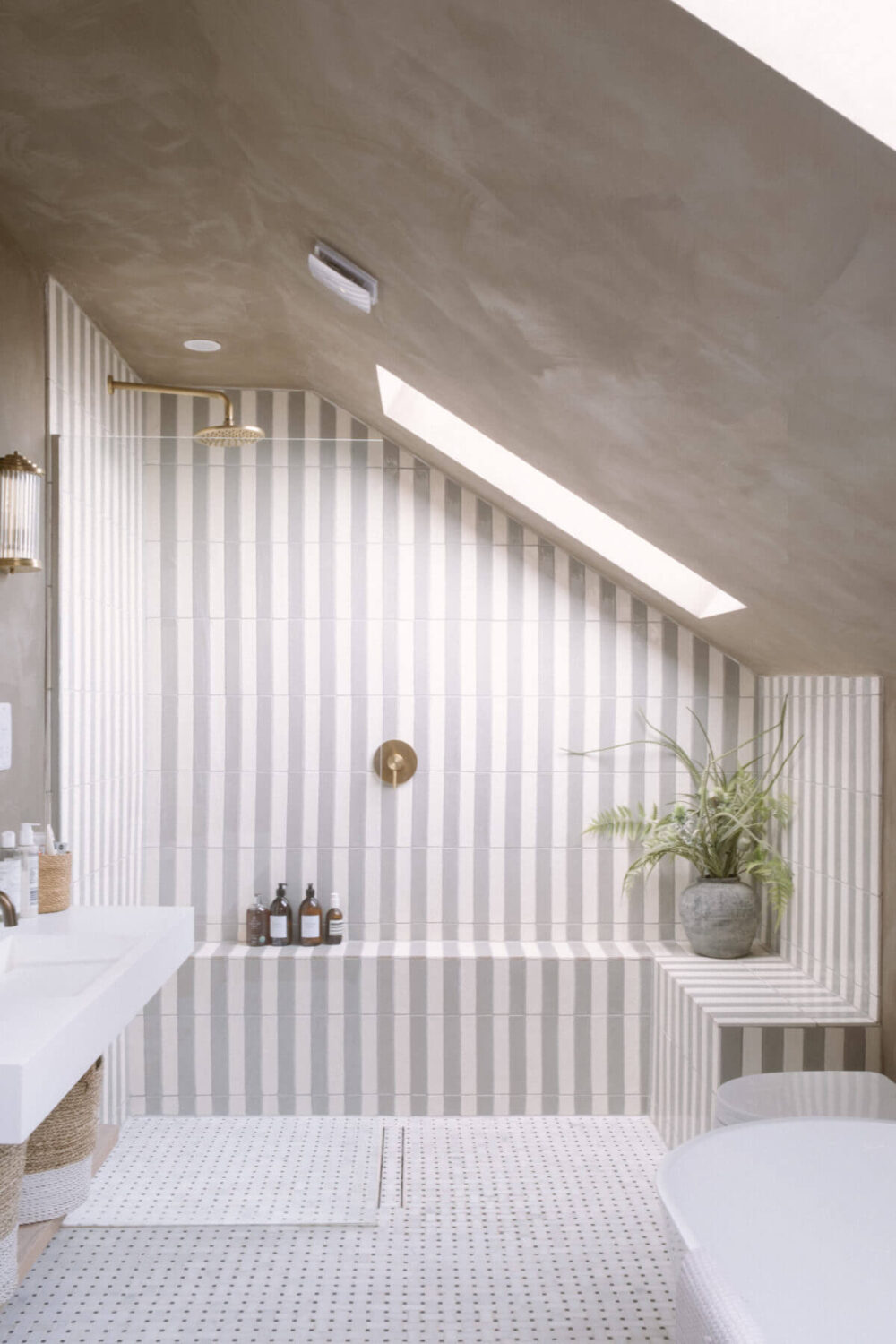 gray-white-bathroom-slanted-ceiling-striped-tilework-nordroom