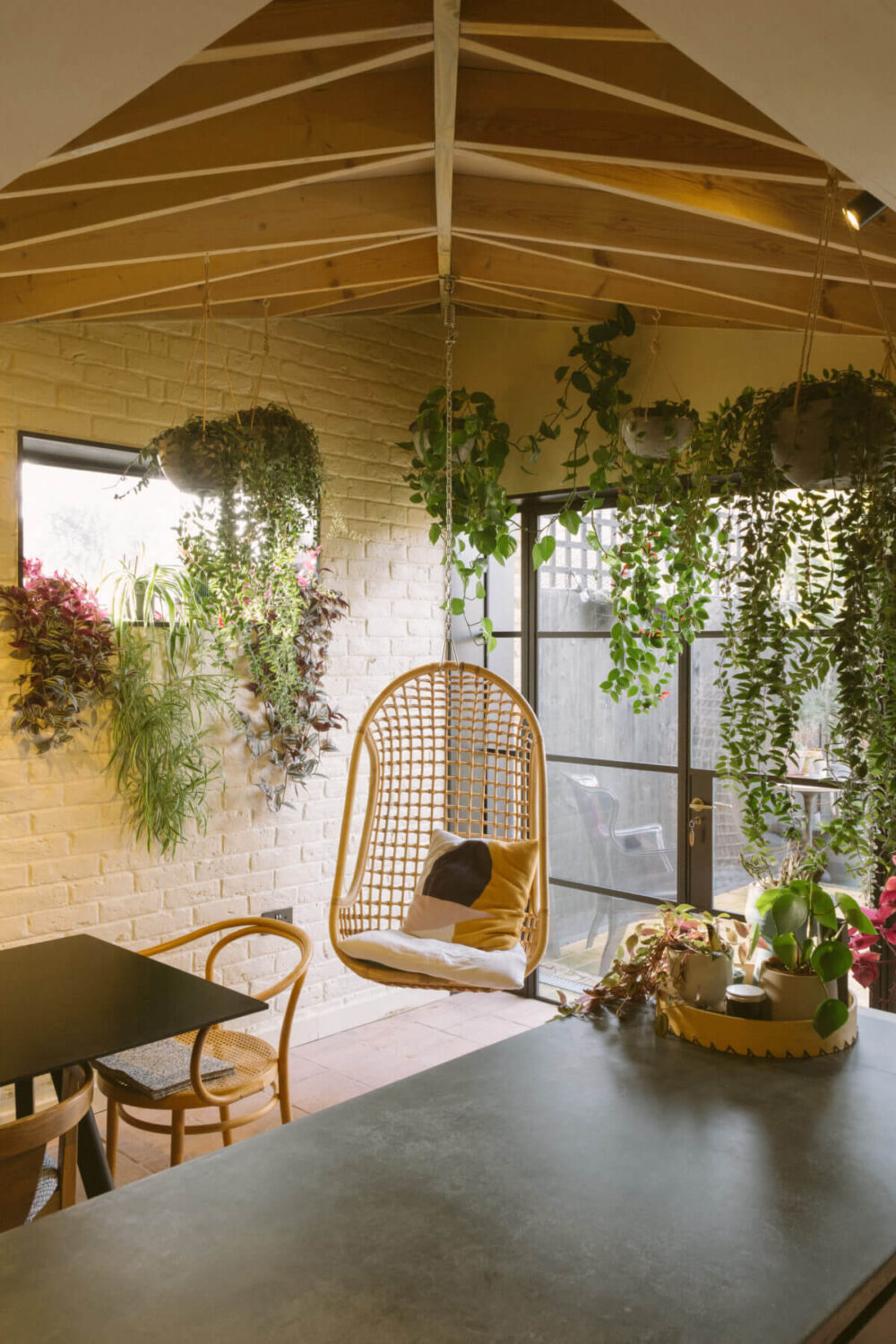 kitchen-exposed-beam-ceiling-rattan-hanging-chair-plants-nordroom