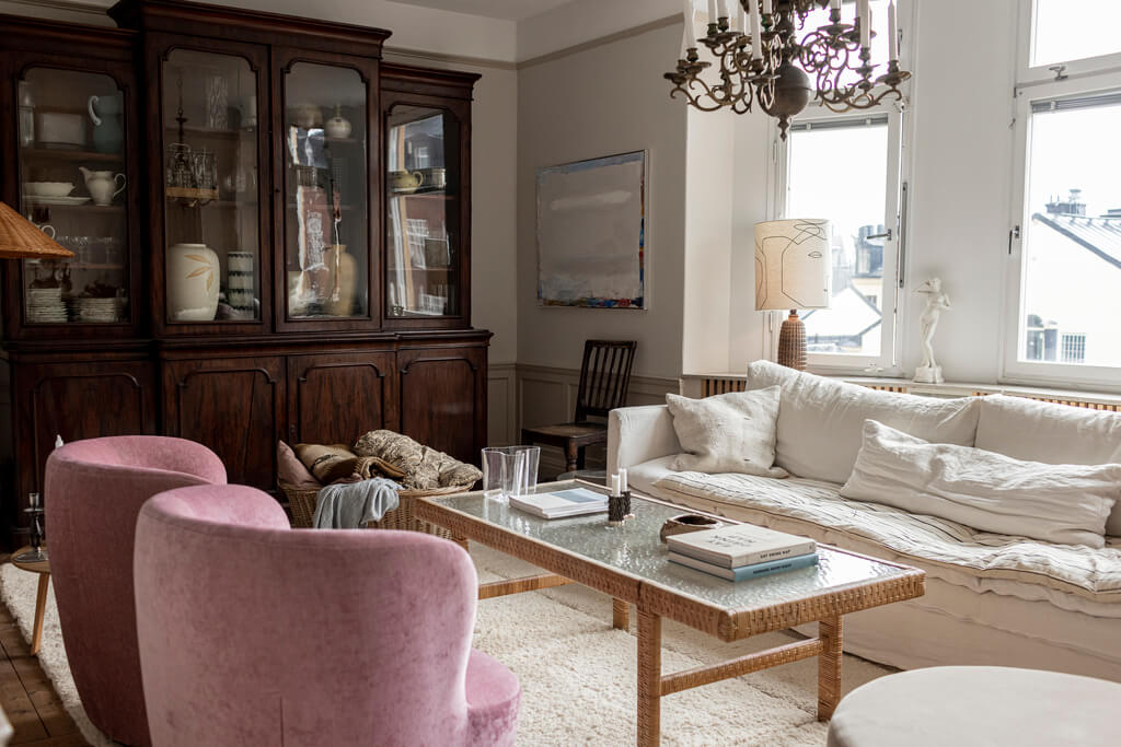 living-room-large-antique-cabinet-pink-armchairs-nordroom