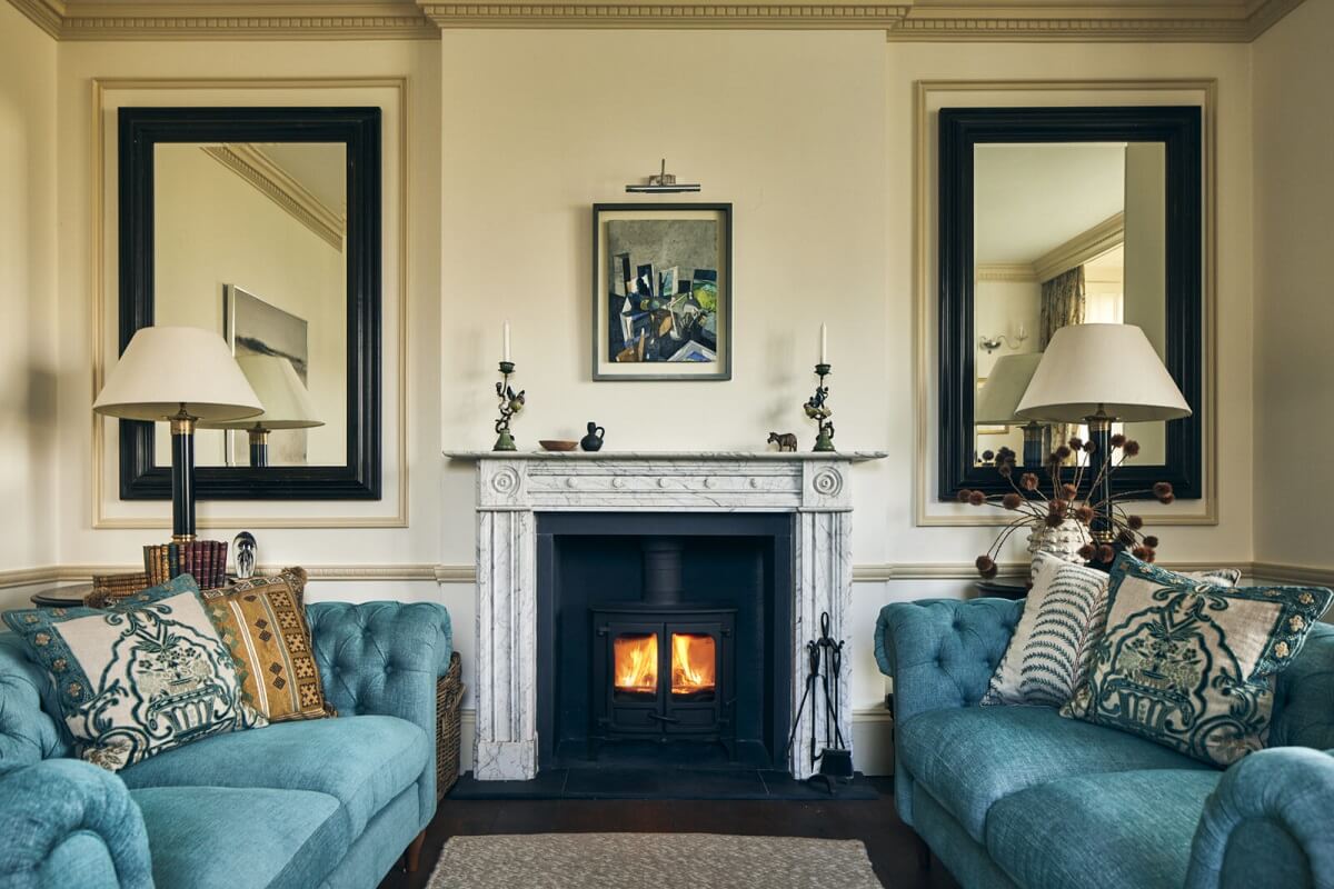 sitting-room-blue-sofas-fireplace-mirrors-nordroom