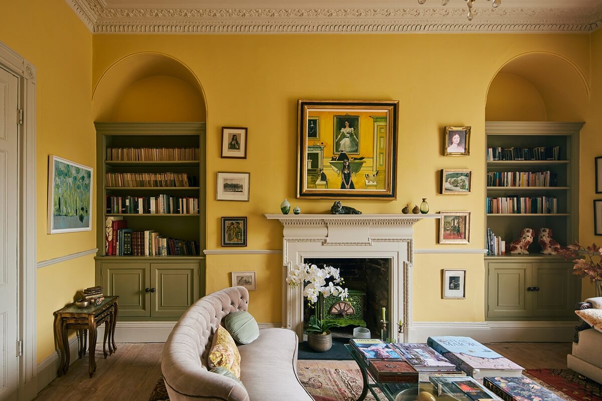 arched-niches-bookcases-fireplace-yellow-walls-sitting-room-nordroom