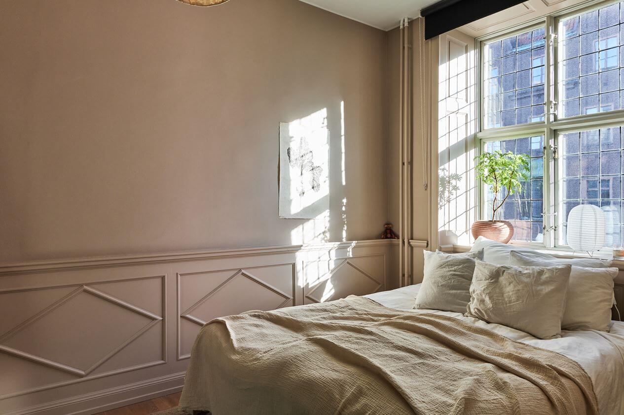 bedroom-natural-light-wood-paneling-light-pink-walls-nordroom
