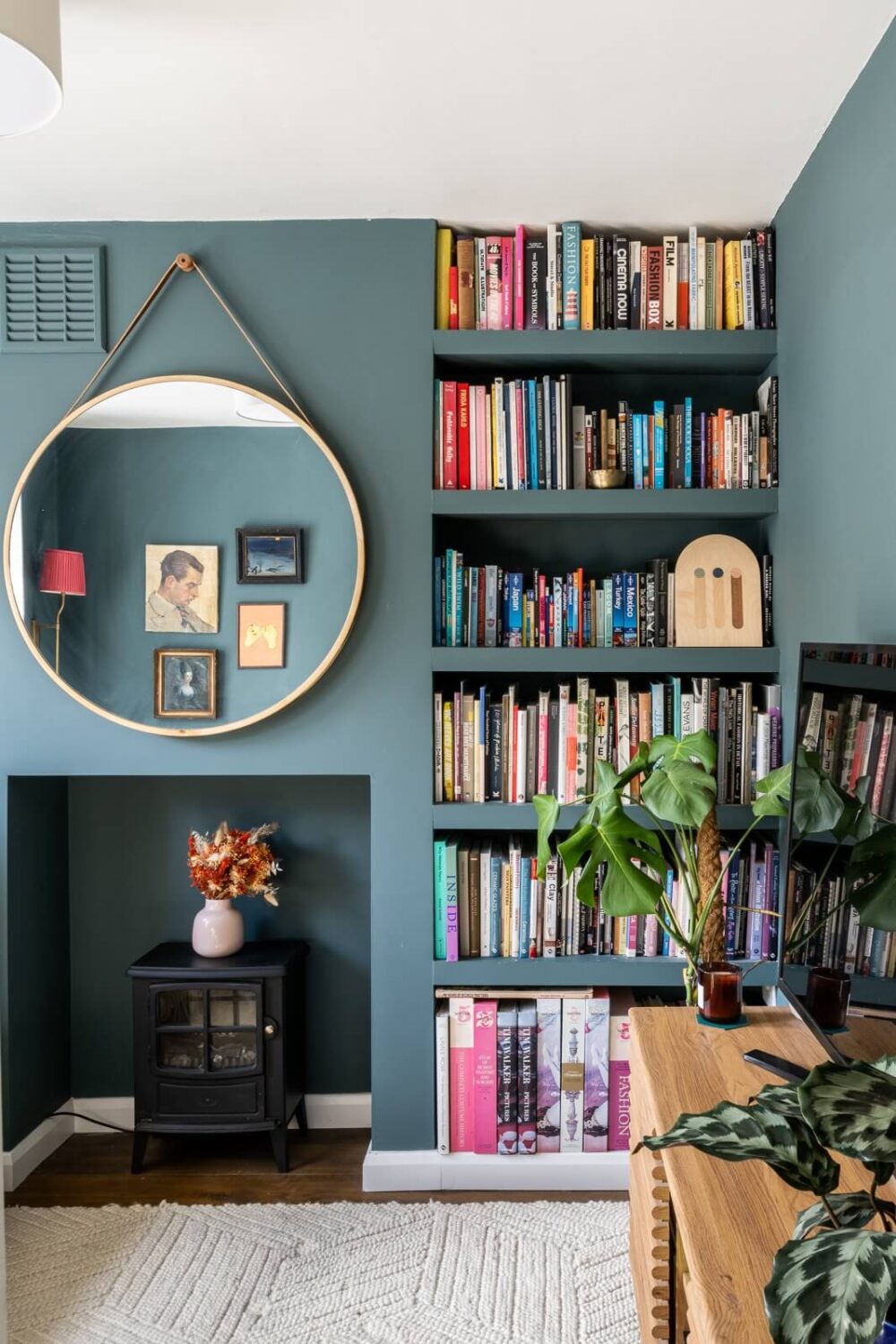 blue-living-room-built-in-bookshelves-round-mirror-nordroom