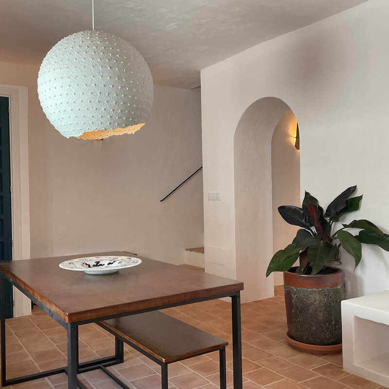 dining-table-living-room-arched-doorway-terracotta-floor-tiles-nordroom