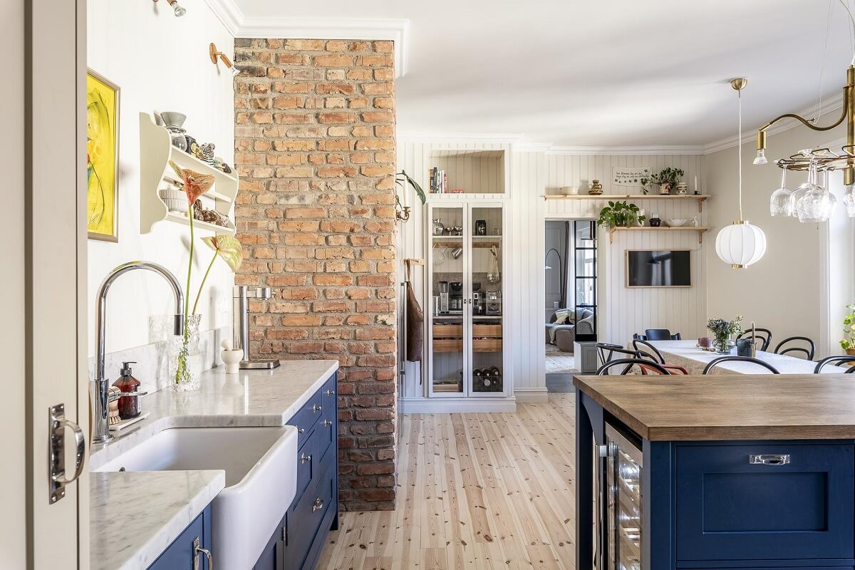 kitchen-blue-cabinets-exposed-brick-wall-nordroom