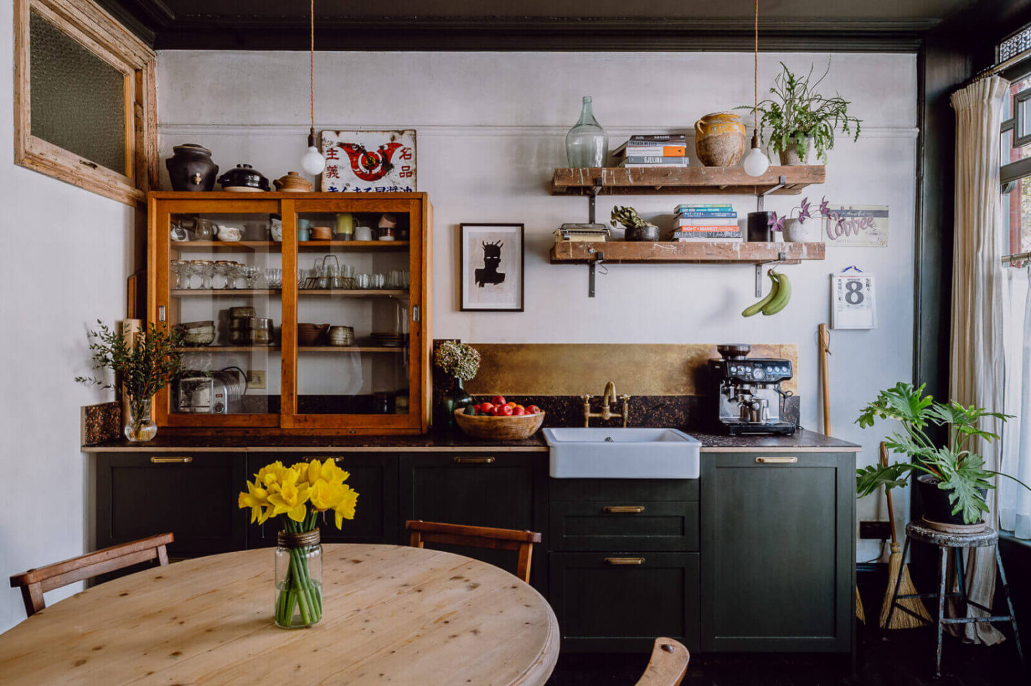 kitchen dark green oak cabinets brass backsplash round kitchen table nordroom