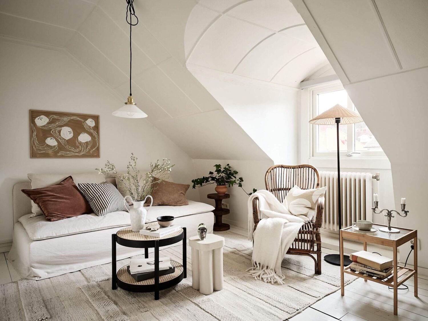 A White Scandinavian Attic Apartment 1 light-attic-apartment-living-room-window-nordroom