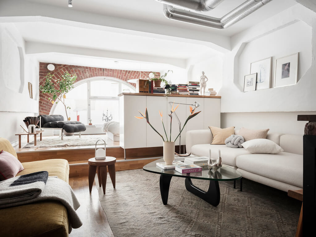 A Scandinavian Loft with Brick Wall and Arched Window