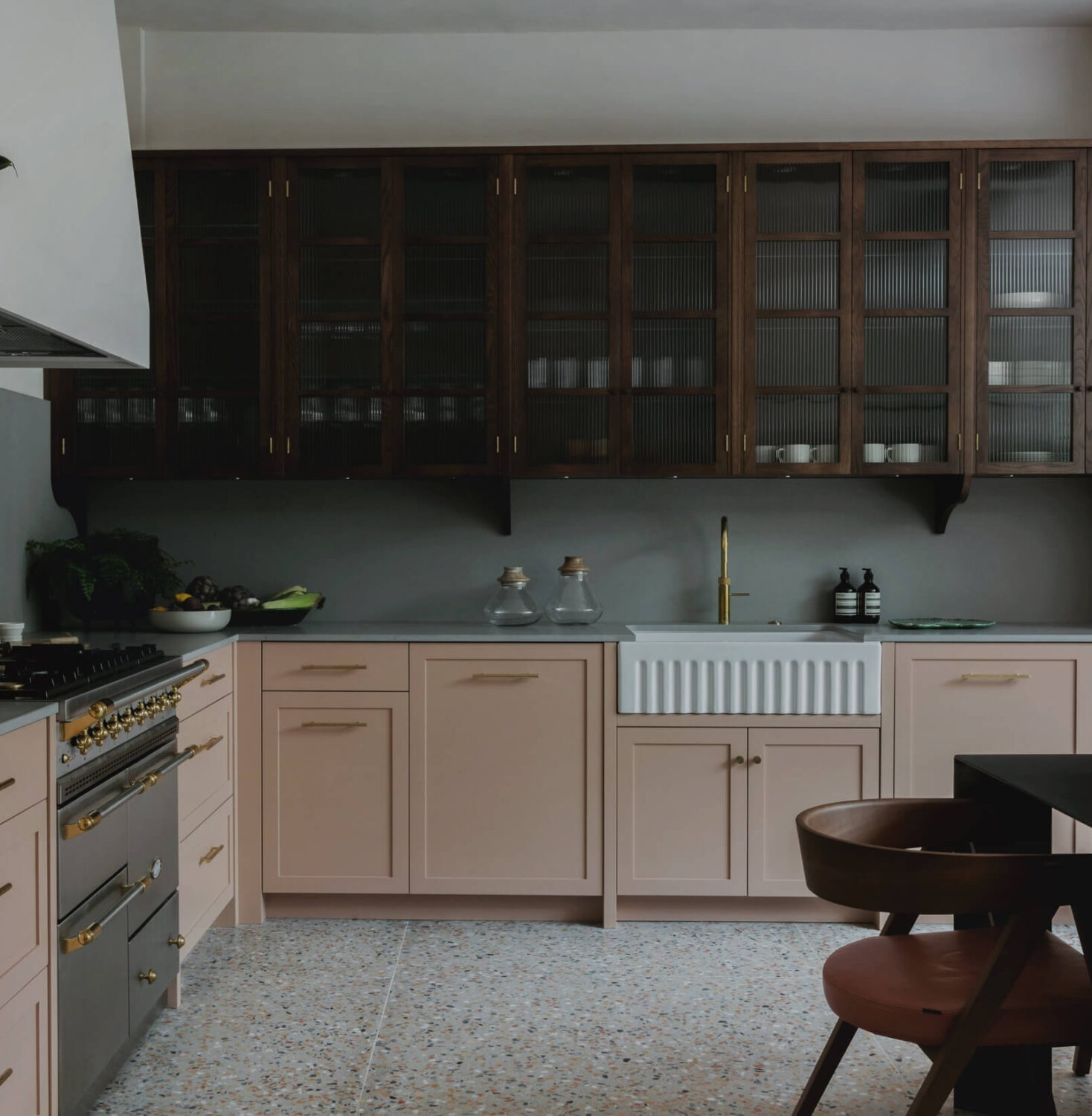 pastel-pink-cabinets-with-natural-wood-ribbed-glass-upper-cabinets