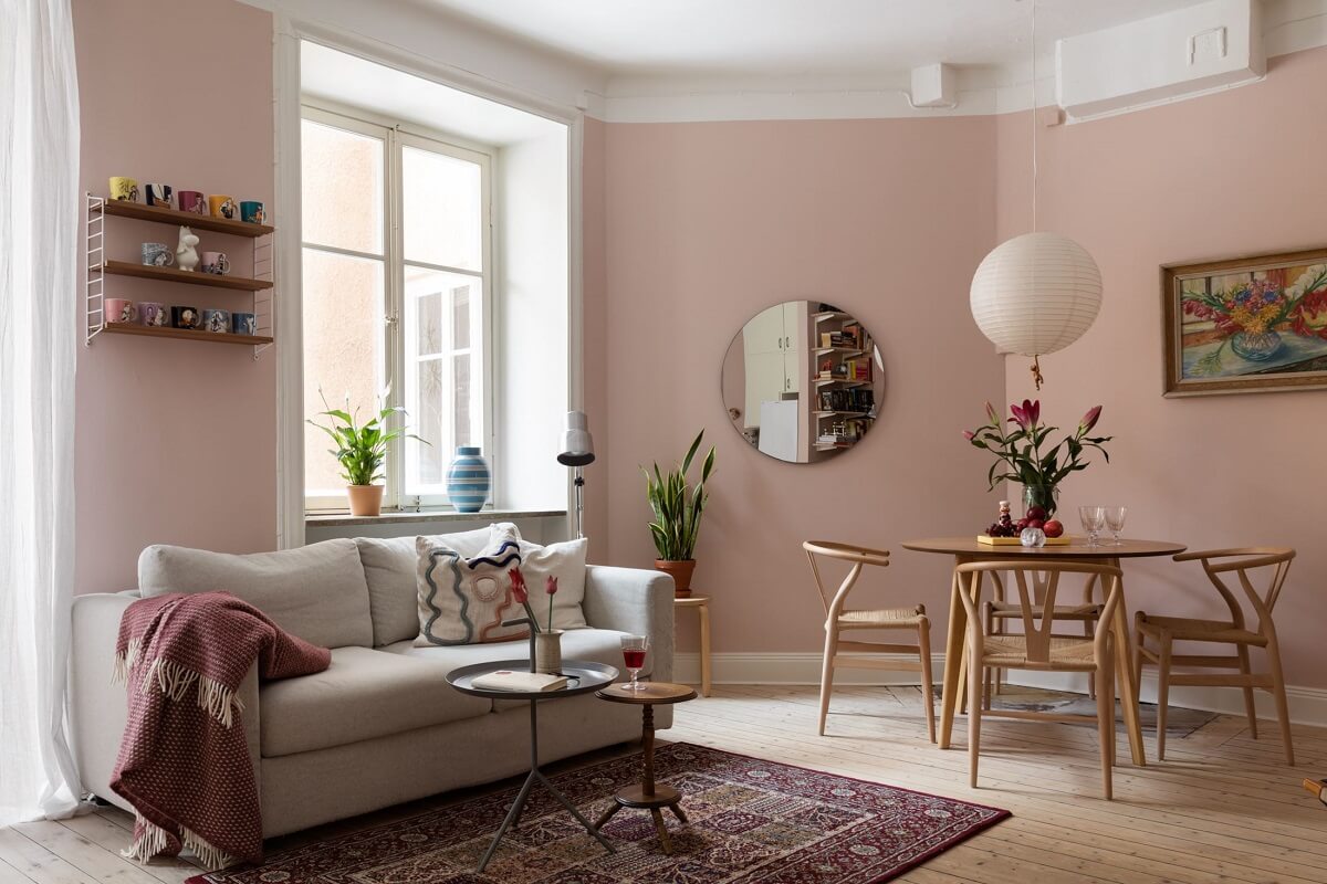 pink-walls-paint-living-room-round-mirror-nordroom