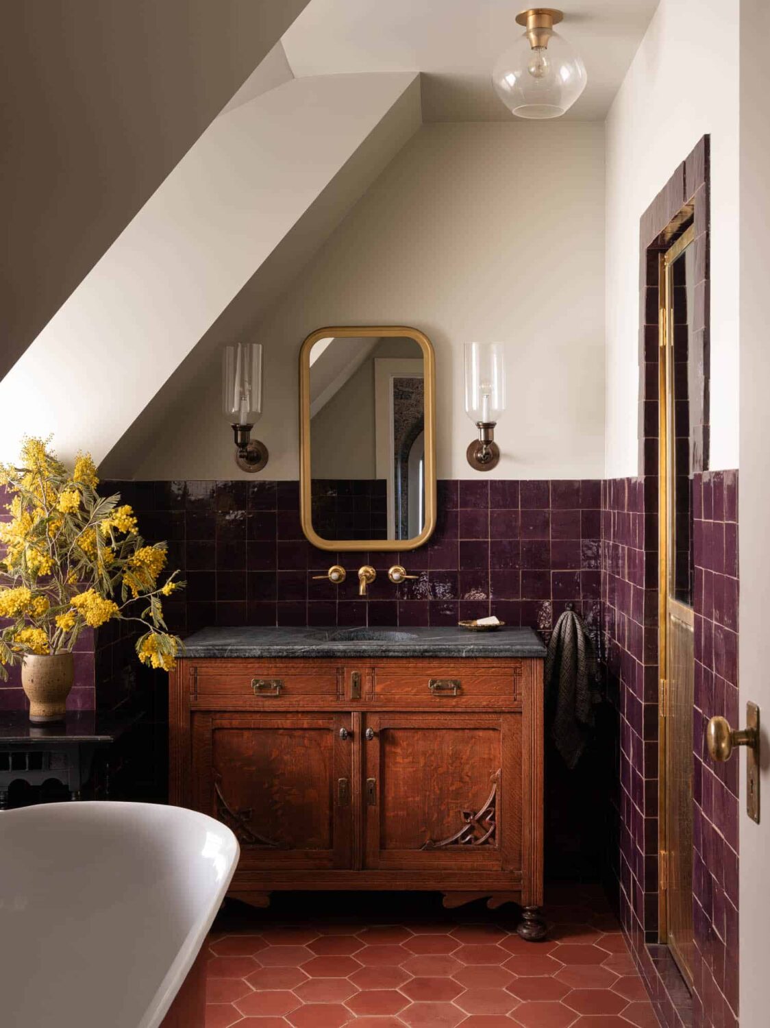 bathroom-antique-sanity-soapstone-sink-purple-tiles-hexagon-terracotta-floor-tiles-slanted-ceiling-nordroom