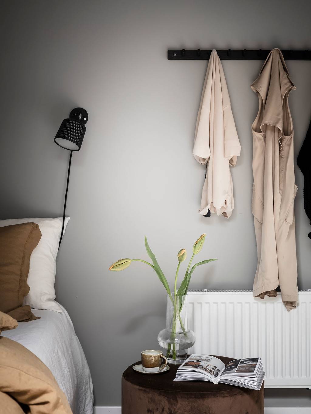 bedroom-detail-gray-walls-wooden-bedside-table-hooks-nordroom